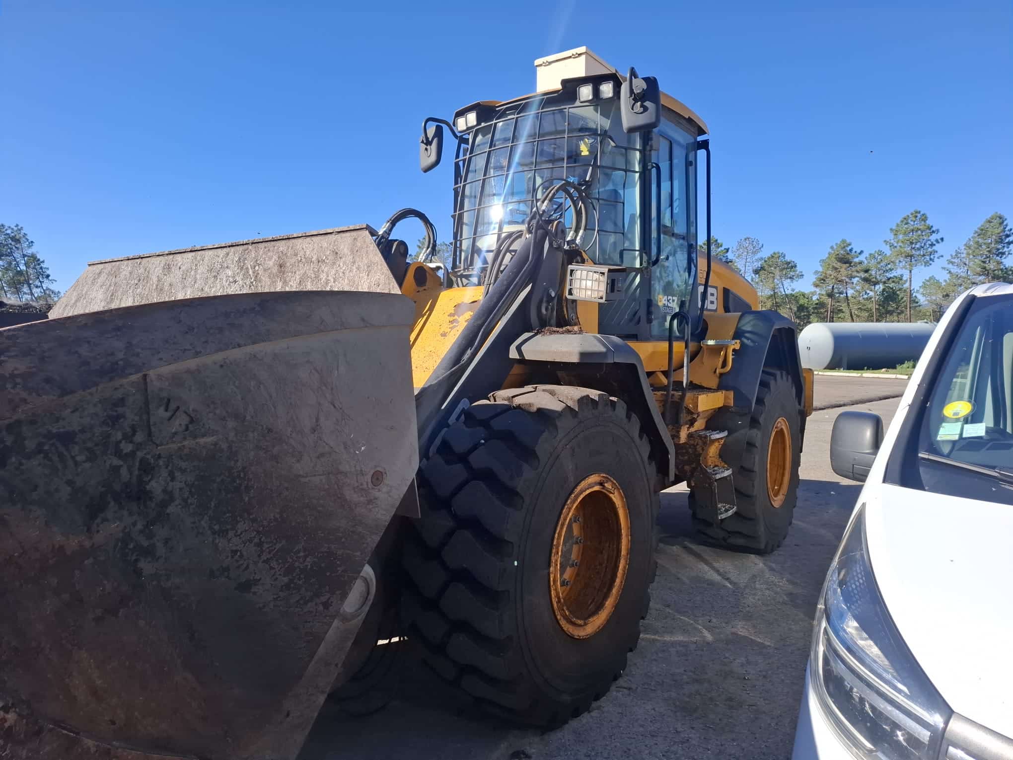 Technicien BH Service en train de diagnostiquer un moteur Cummins B6.7 sur une chargeuse JCB 437, lecture des codes défauts et analyse électronique.